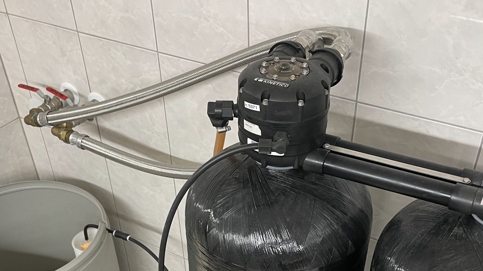 The control valves on top of a twin-tank water softener