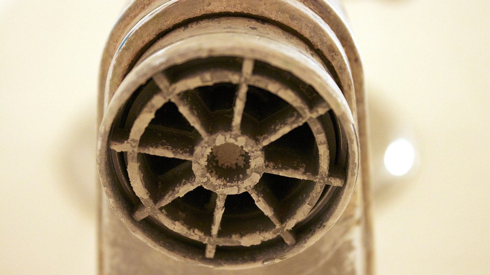 A tub spout aerator crusted with white calcium scale