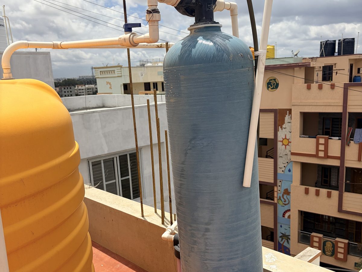 A water softener tank installed on a supply line