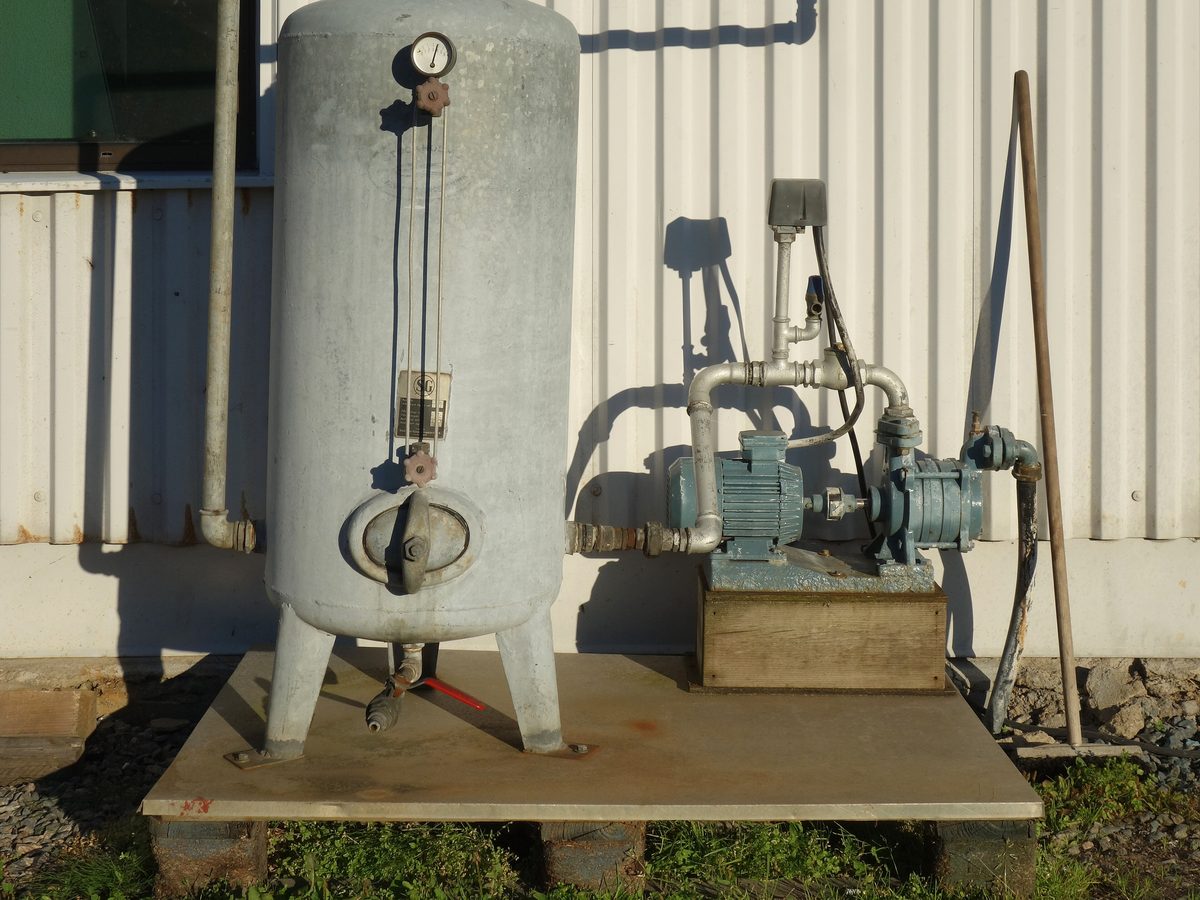 A pressure tank and pump on a water well